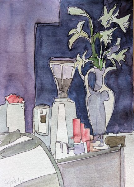 A large jug of lilies sits next to a coffee grinder and other cafe items on a counter top.